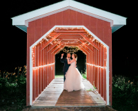 Bride and Groom on a covered Bridge