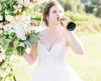 Bride drinking champagne out of the Bottle