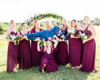 Bridesmaids holding the groom.