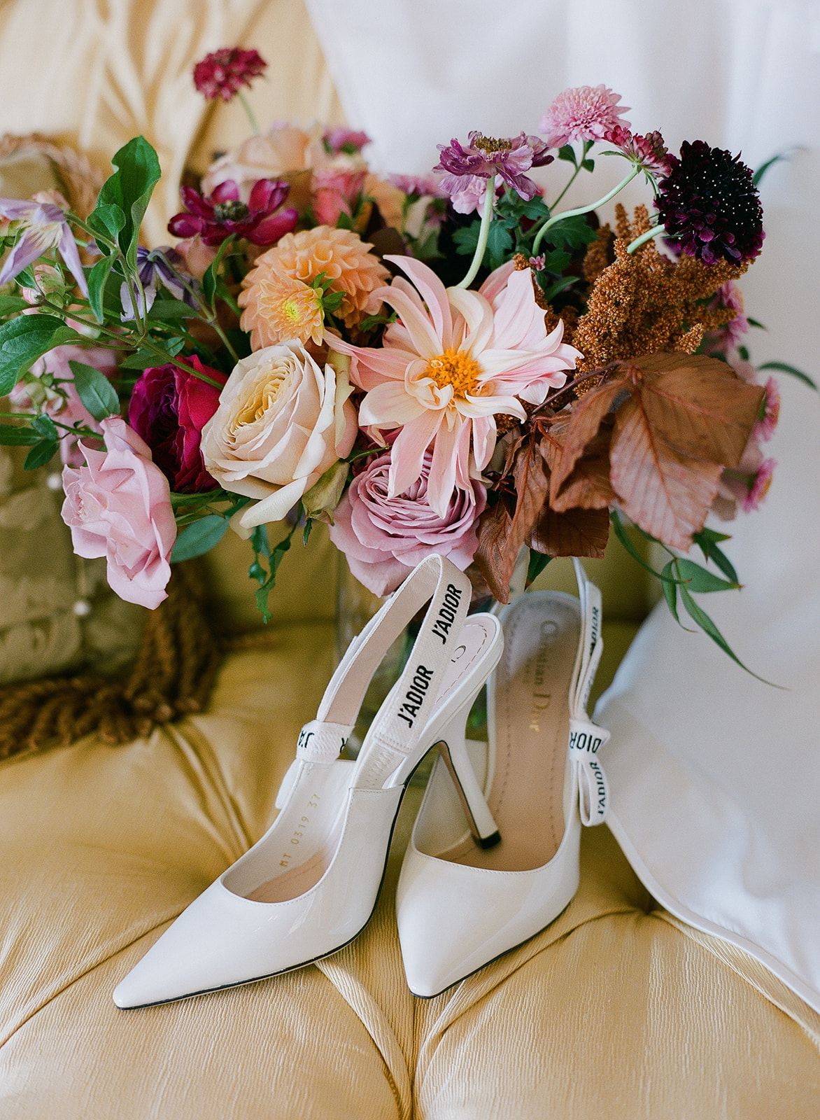 Designer shoes in a chair with bouquet