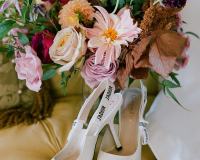 Designer shoes in a chair with bouquet