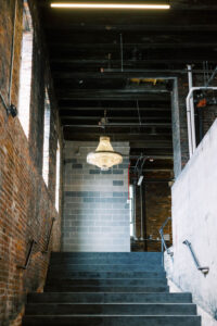 Staircase and chandelier at Autoshop, a modern industrial event space in D.C. for stylish weddings and mitzvahs