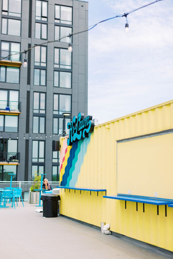 Outdoor rooftop bar at Hi-Lawn in Union Market with colorful mural and skyline backdrop for weddings and mitzvahs