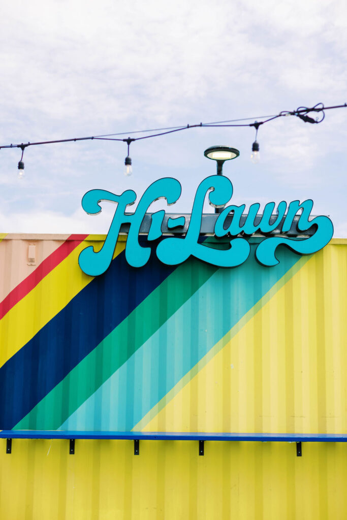 Hi-Lawn rooftop venue at Union Market District with yellow shipping container bar, colorful mural, and city backdrop – ideal for weddings and mitzvahs