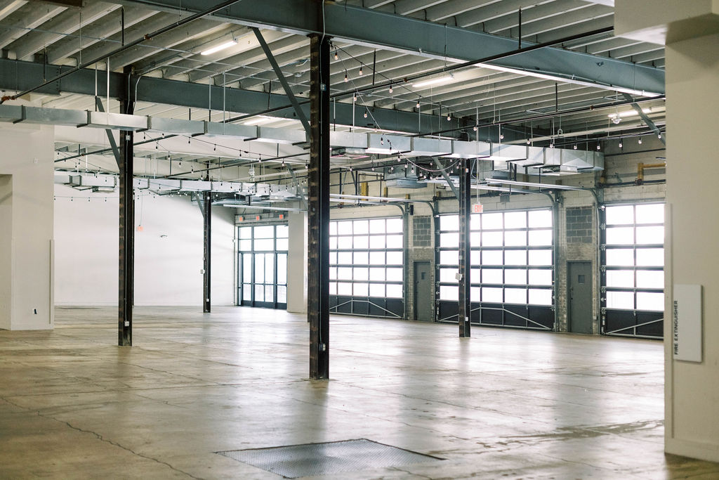 ndustrial wedding and mitzvah venue interior at Dock5 in Washington, D.C., with concrete floors, steel beams, and garage doors — ideal for large-scale events