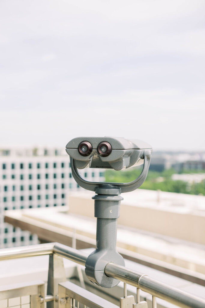 Spy Museum rooftop binoculars overlooking Washington, D.C.—a modern mitzvah and wedding venue in the city