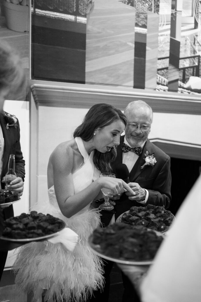 Bride and her father joyfully reacting to a surprise brownie display during the wedding reception at The Branch Museum. Richmond Va Wedding. 