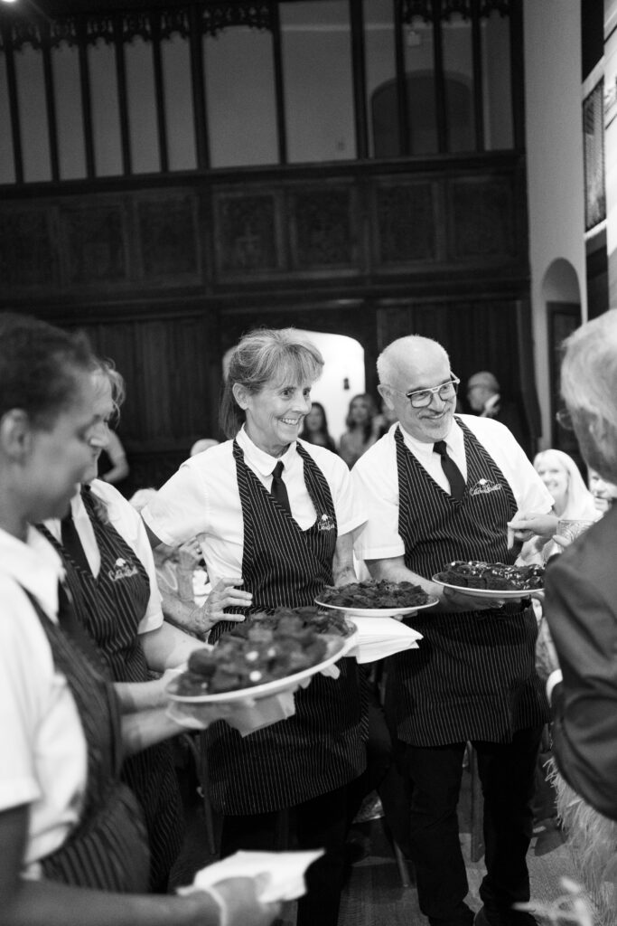 Catering team presenting trays of nostalgic brownies to guests during a Richmond wedding reception at The Branch Museum.