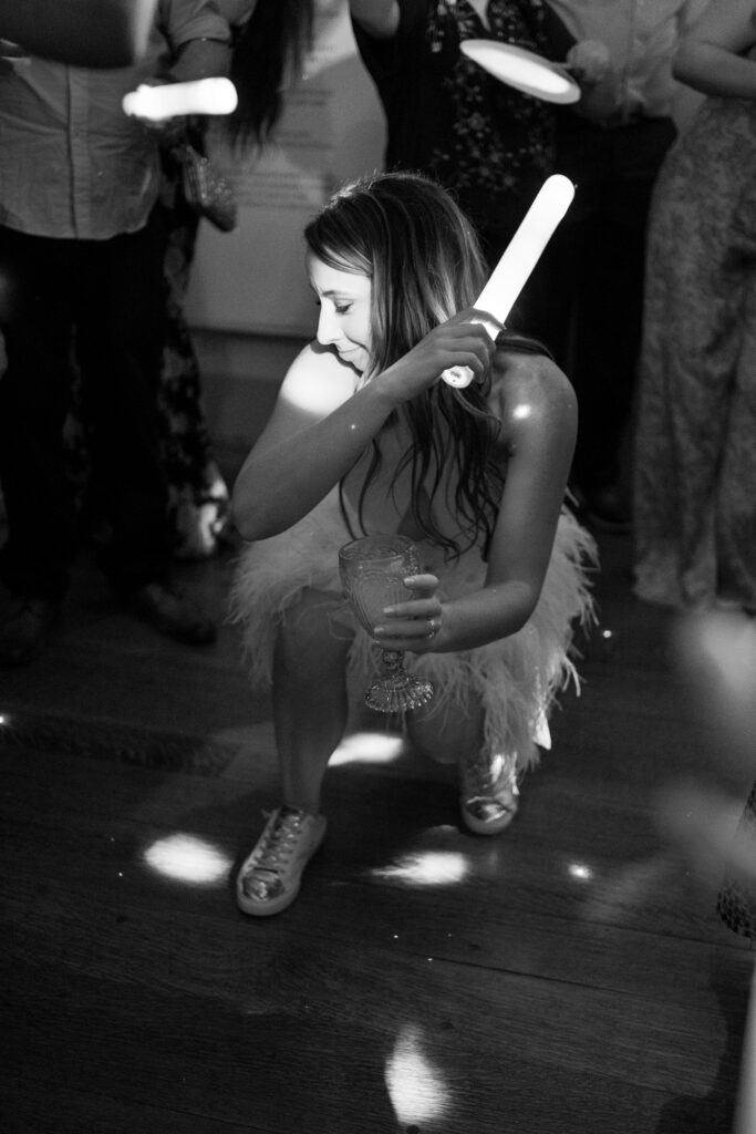 Fun wedding reception moment with bride dancing in sneakers under disco lights in Richmond. Richmond Virginia, wedding planner
