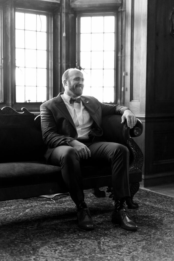 Groom sitting in the parlor at The Branch museum before his wedding. Richmond VA weddings