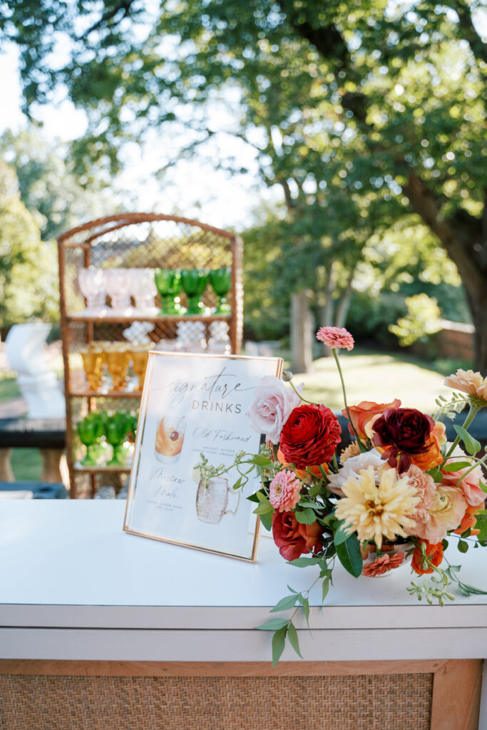 Signature cocktail bar setup with seasonal florals at The Branch Museum wedding in Richmond, VA, planned by luxury wedding planner Swoon Soirée. Fall wedding Richmond Va