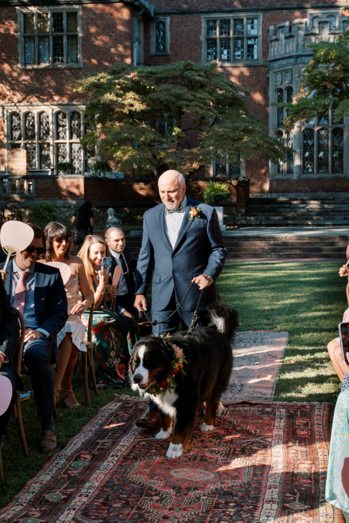 Wedding ceremony at The Branch Museum with Bernese Mountain Dog walking down the aisle with groomsman, Richmond wedding