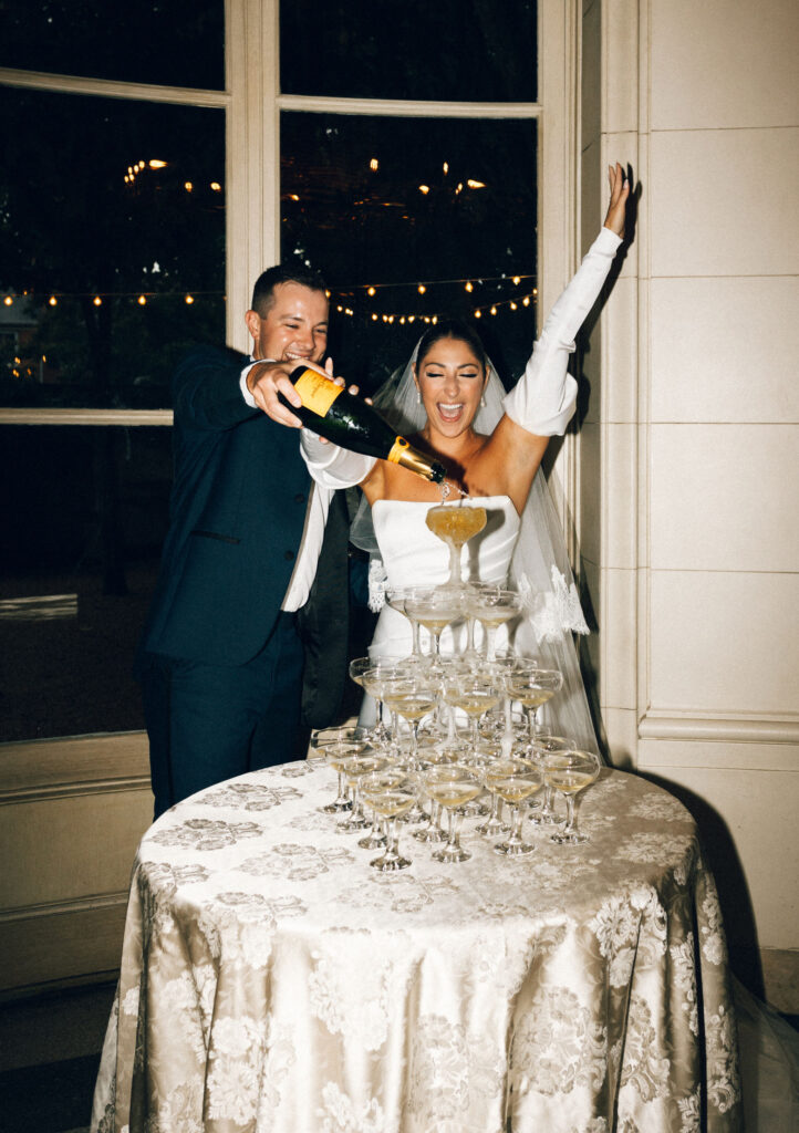 Bride and groom pouring champagne tower during wedding reception at Meridian House in Washington DC