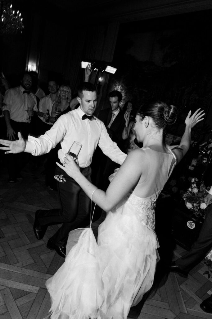 Black and white photo of the bride and groom dancing joyfully at their Meridian House wedding reception.