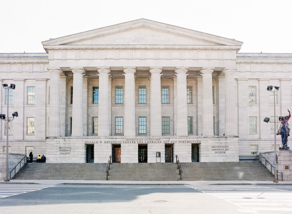 Exterior view of the National Portrait Gallery in Washington, D.C., showcasing its neoclassical architecture with grand columns and historic façade. DC wedding venue. Ideal for editorial wedding portraits.