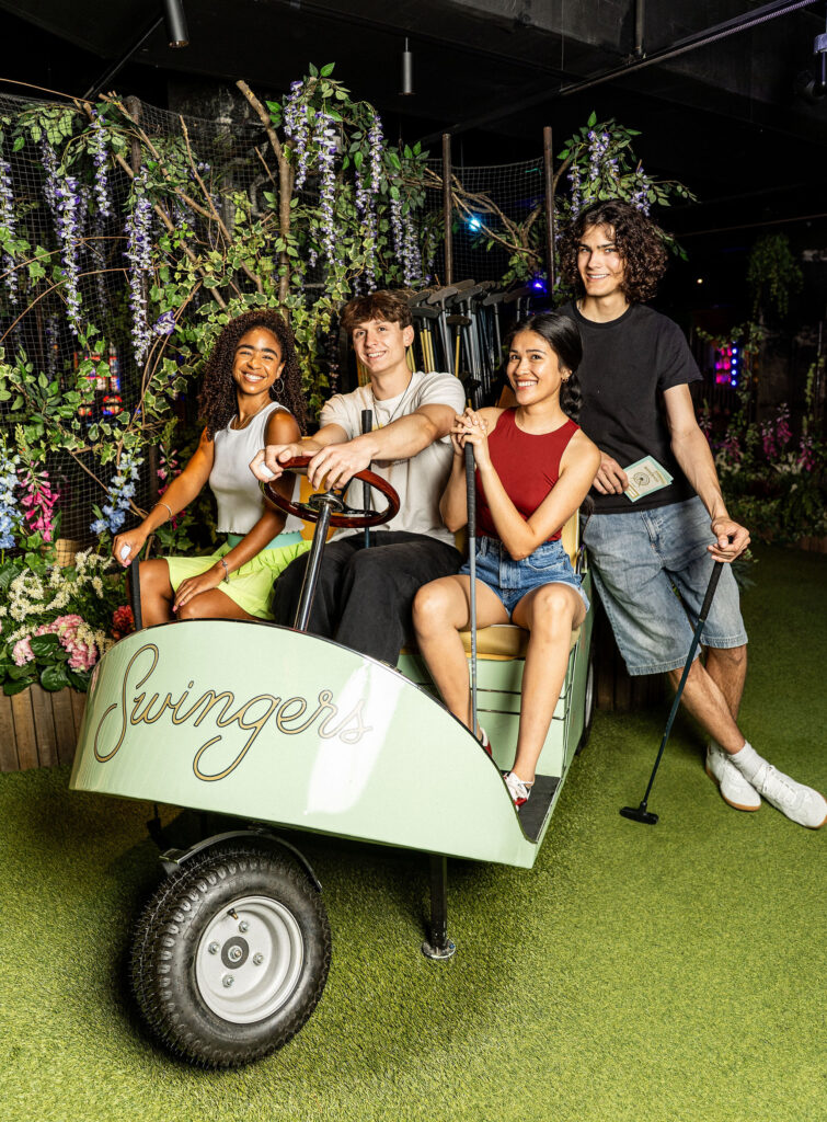 Teen guests sitting on the Swingers Golf Cart at a Bar or Bat Mitzvah during mitzvah celebration at a Bar or Bat Mitzvah at Swingers Carnival Washington DC