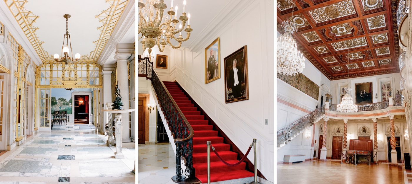 A tall, red-carpeted staircase lined with painted portraits