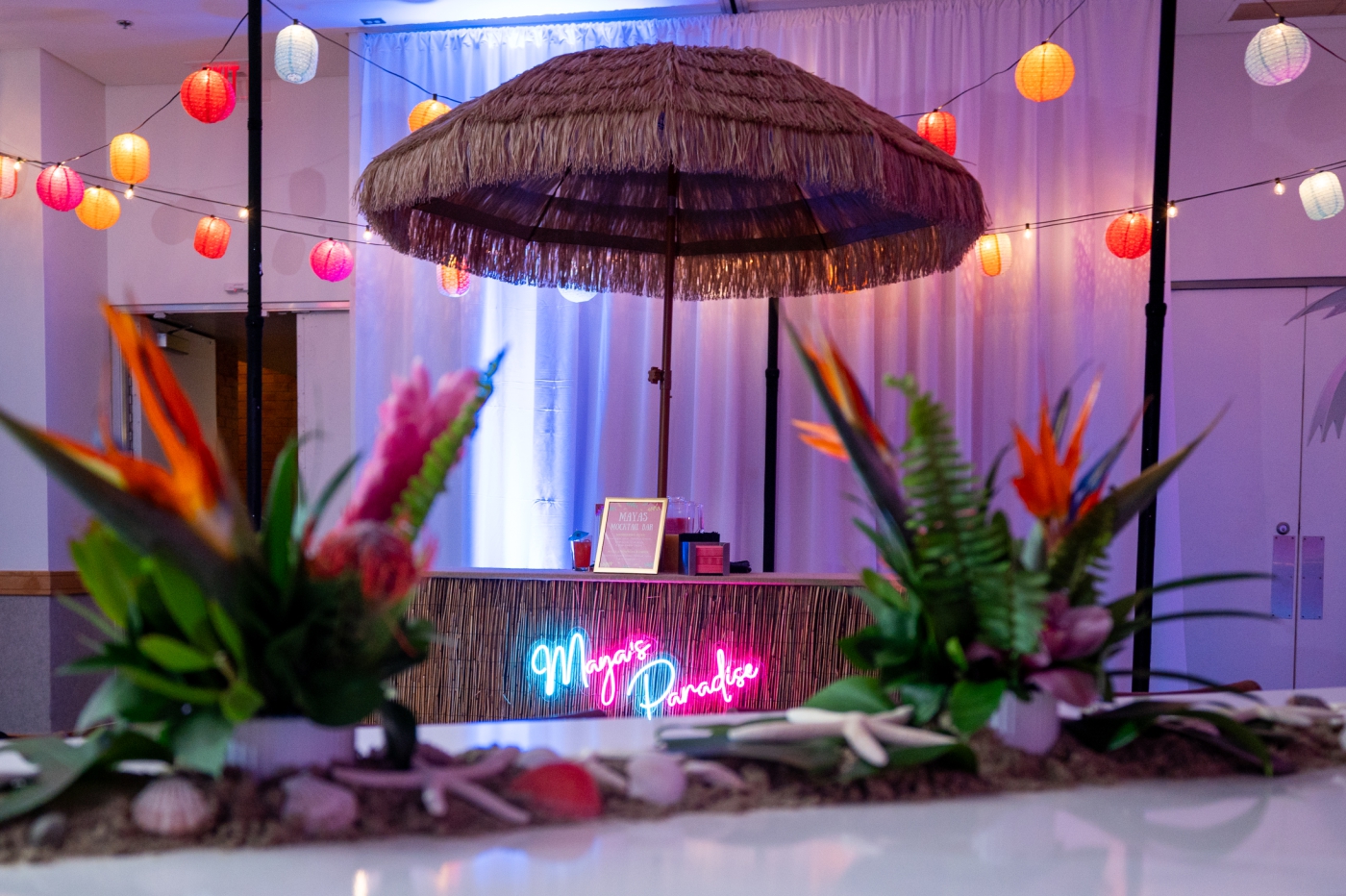 Tropical plants and a straw patio umbrella at a tropical-themed Bat Mitzvah in Virginia