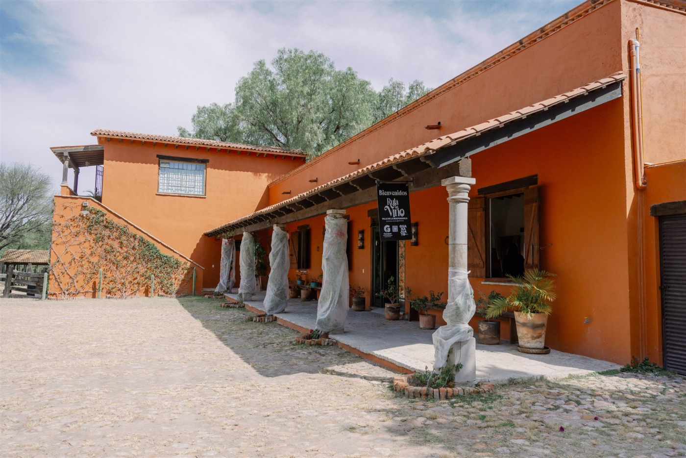 A long, single-story home in a terra cotta color at Rancho Las Sabinas