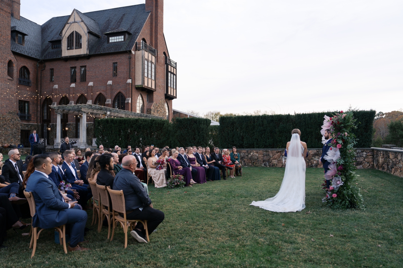 A wedding ceremony with Dover Hall in the background